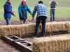 Slotting in bales.  Snugly, too tight will push the other bales out, & too loose will leave gaps