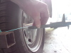 Distance from string at front edge of wheel, 1mm more than the back of wheel, on both left & right.  Spec. 1/16